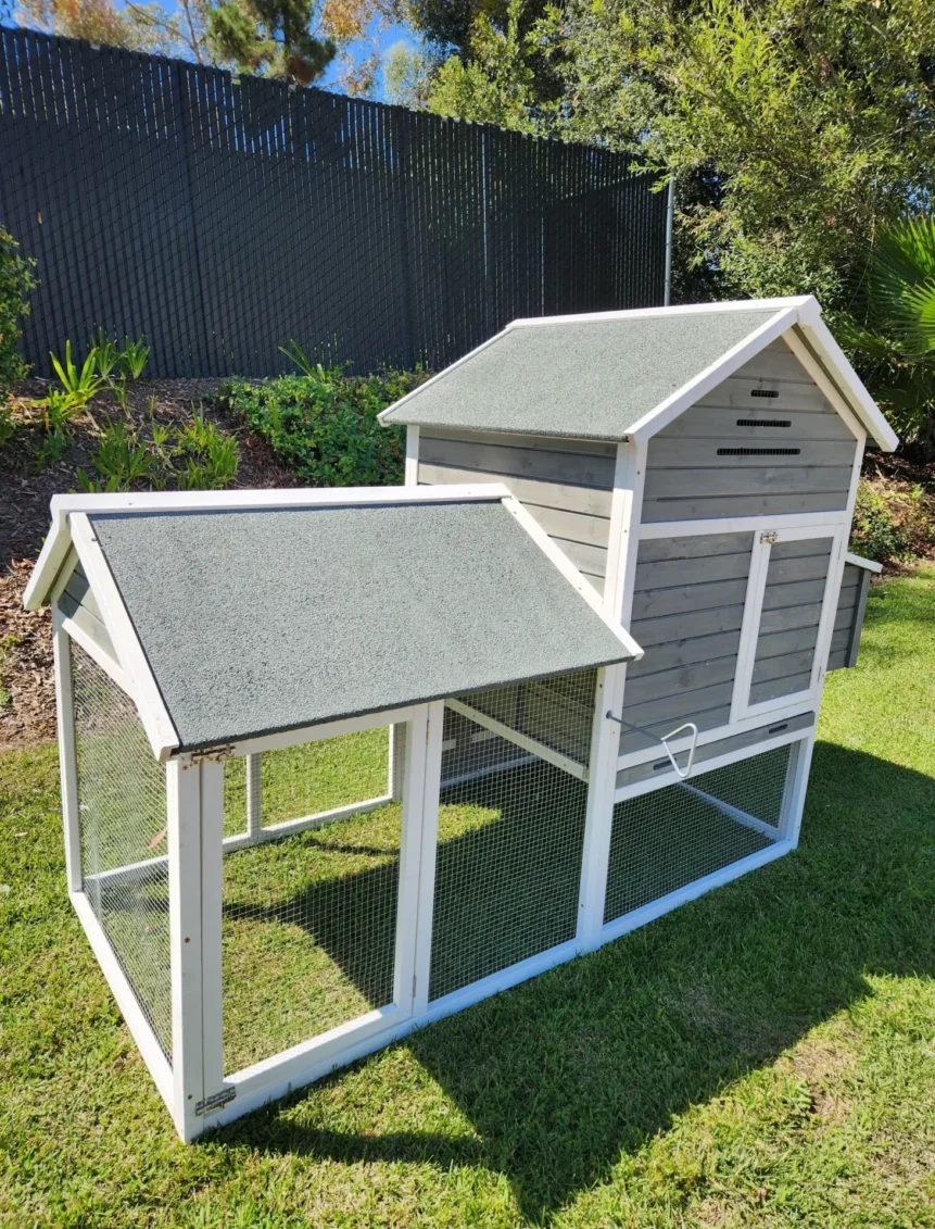 Gray wooden chicken coop with attached run