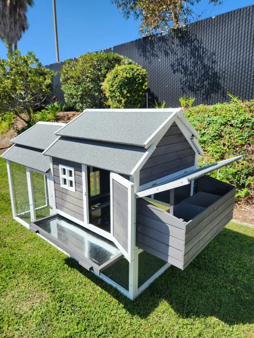Small gray wooden chicken coop on grass